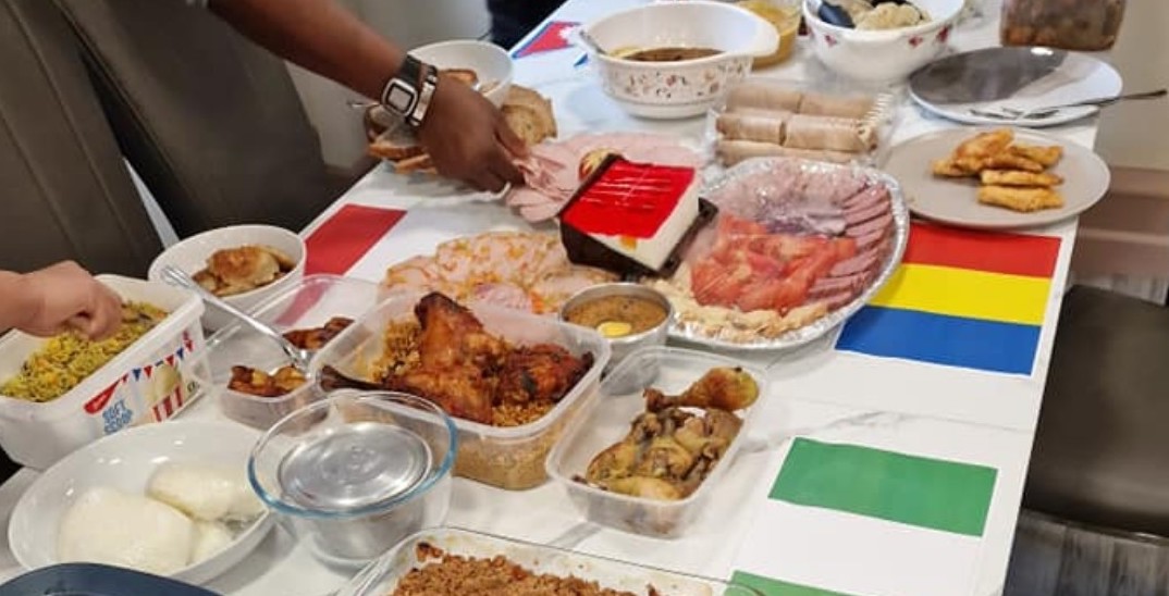 Lots of different foods with the flags of Nigeria and Romania