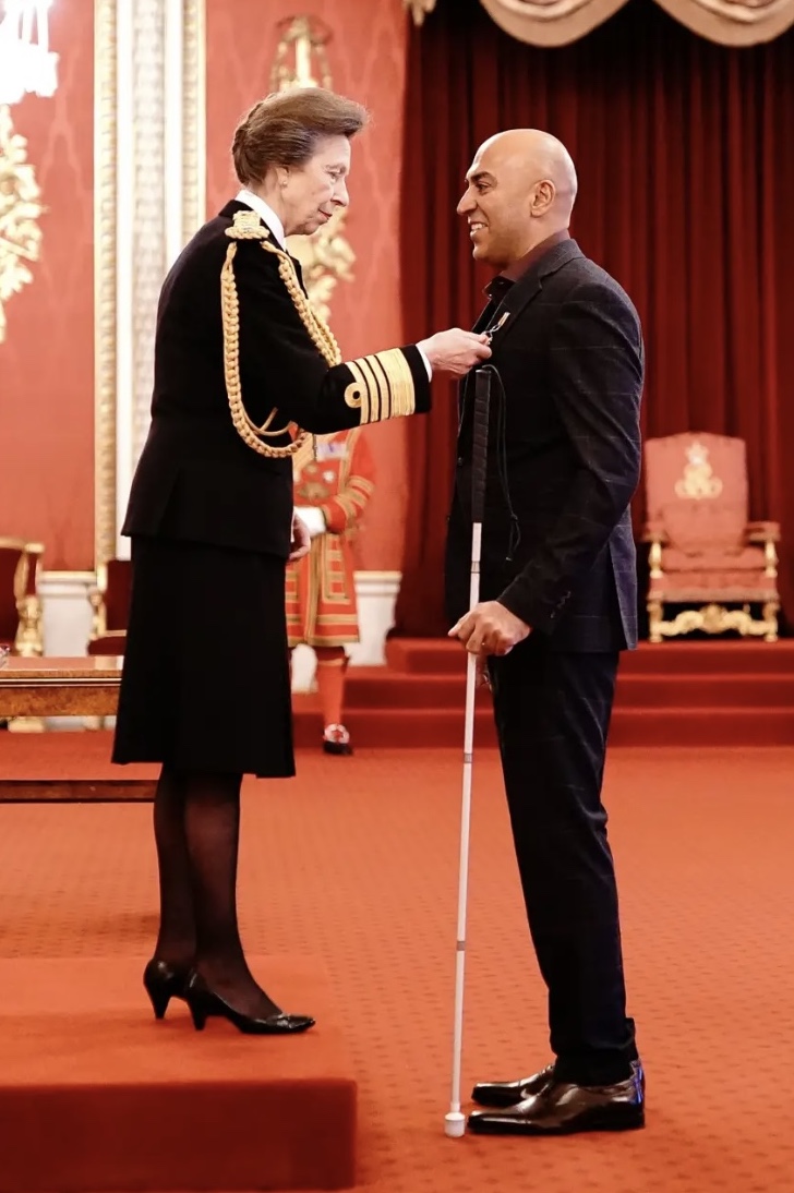 Amar receiving his OBE from HRH Princess Anne