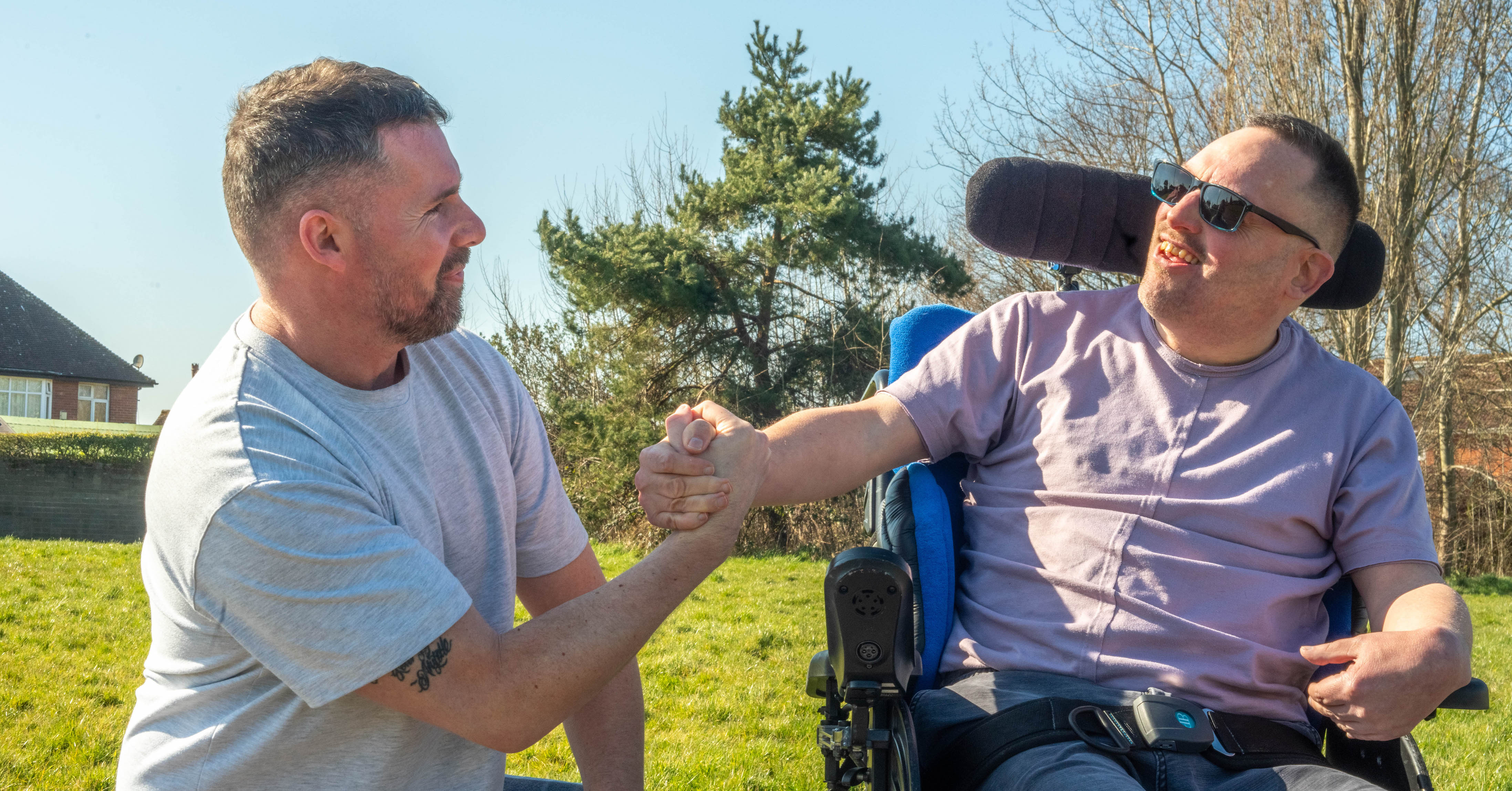 James and Carl clasping hands