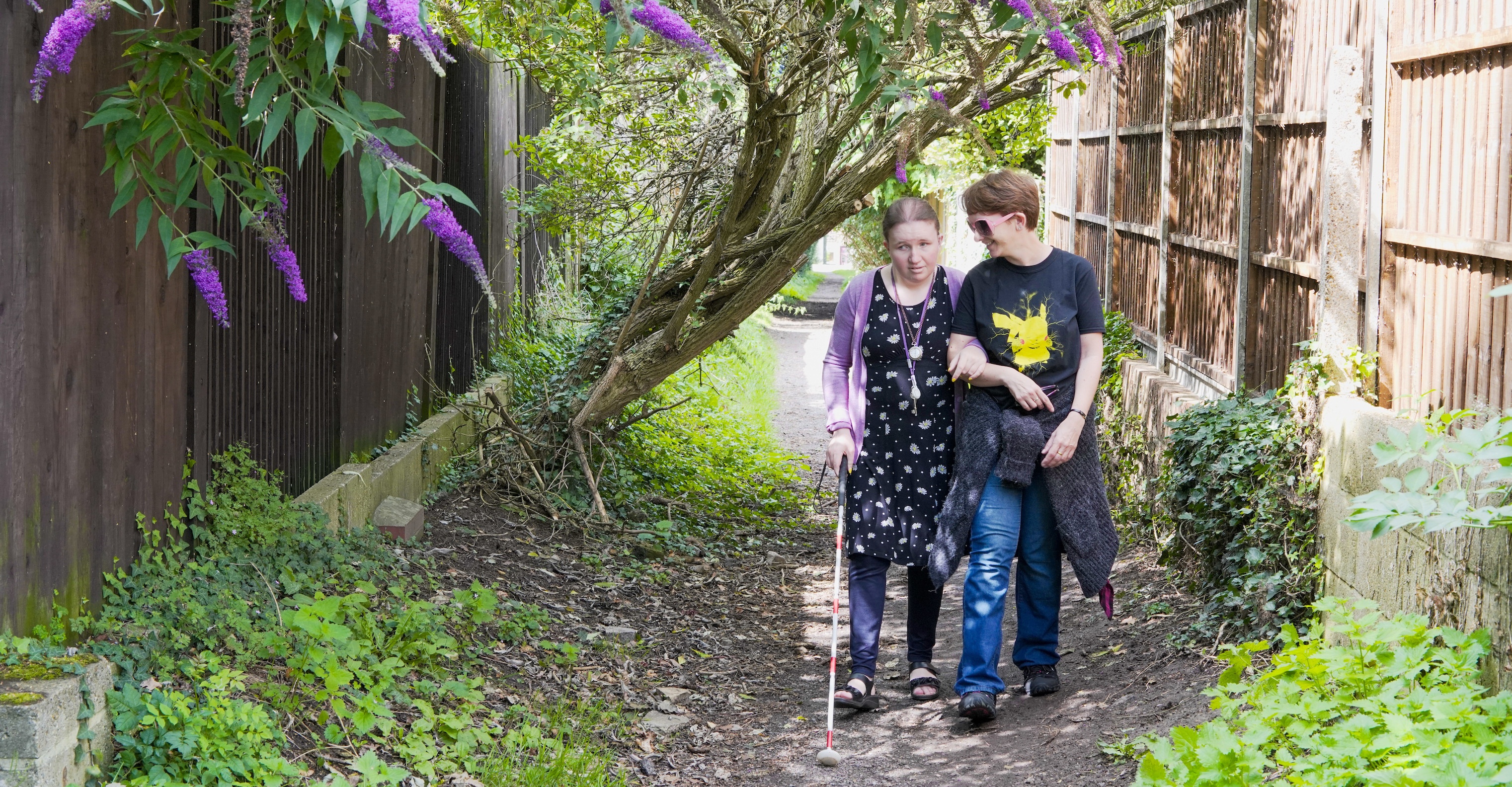 Kayleigh supported by a sighted guide