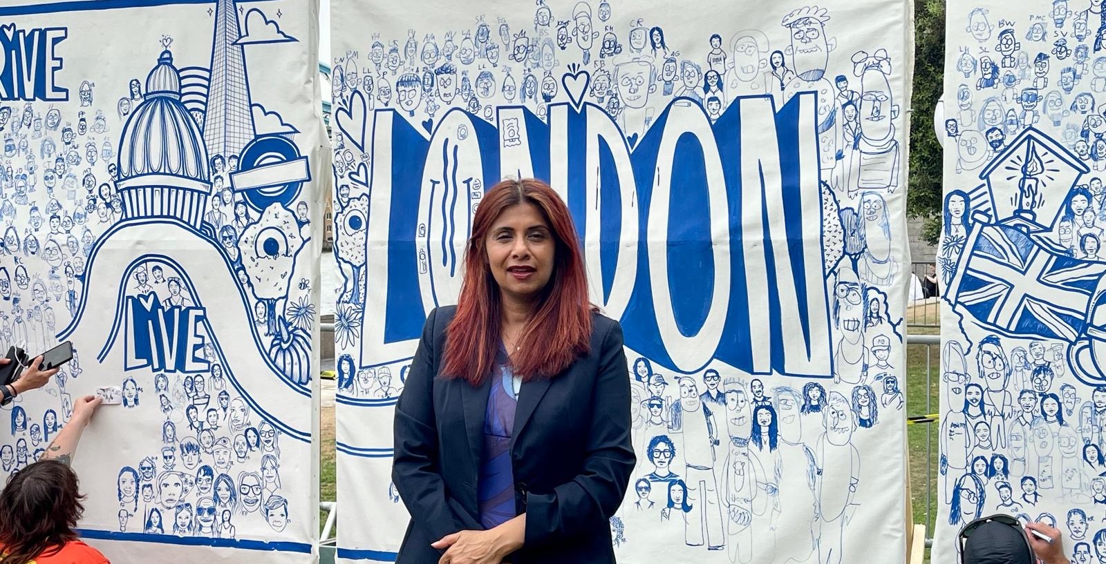 Marina Ahmad stands in front of our record-breaking mural