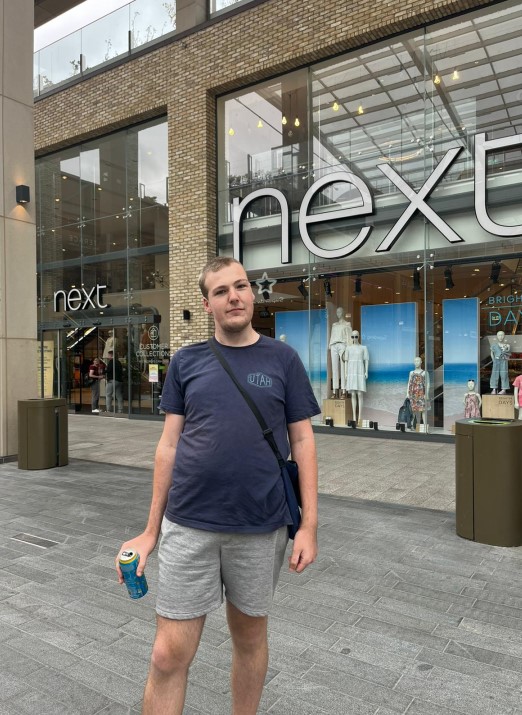Tim standing in front of Next, where he works