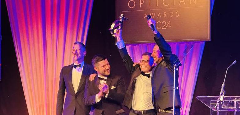 Martyn on stage cheering with his trophy