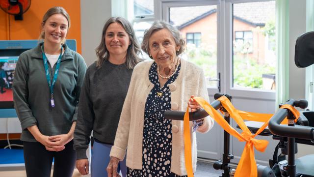 Lady Judith Colman cutting the ribbon on the Innowalk with two Heather House Physiotherapists