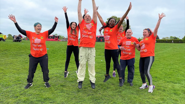 A SeeAbility challenge team jumping and cheering