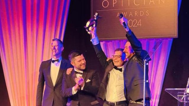 Martyn on stage cheering with his trophy